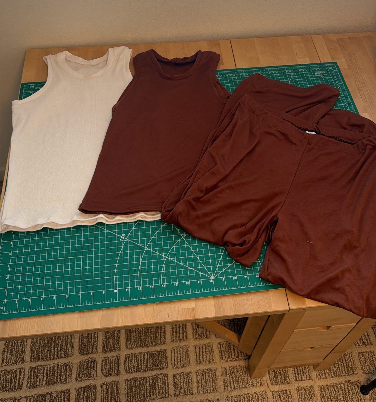 The finished white Sylvan tank, brown Sylvan tank, and brown Sally pants laid out together